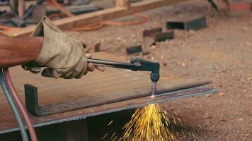 The hands of a mechanic are using a steel cutting tool. video