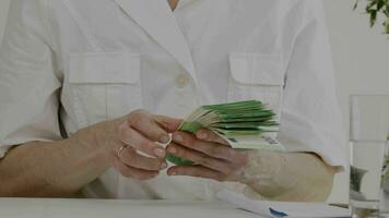 a person is counting money in front of a table video