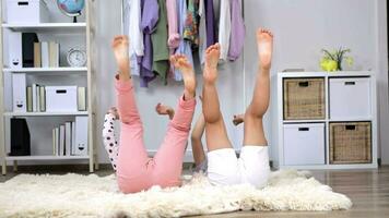 two children sitting on a rug in a room video