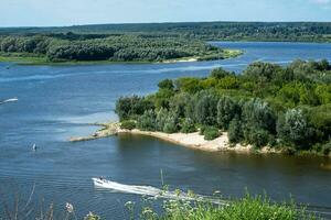 Landscape in a continental climate with a bend in the river and wooded banks photo