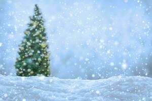 Empty white snow with blur Christmas tree with bokeh light background photo