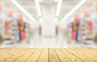 Empty wood table top with supermarket blurred background for product display photo