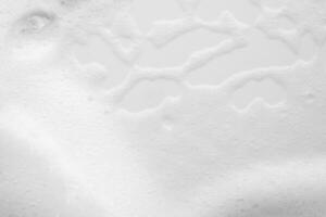 Abstract white soap foam bubbles texture on white background photo