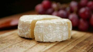 Camembert cheese on a bowl on table , video