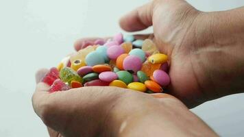 slow motion of dropping colorful sweet candy on table video
