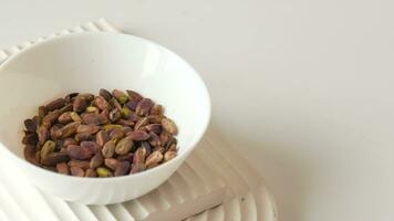 Pistachio kernel nuts in a bowl on table video