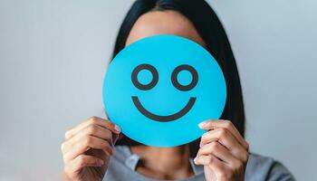 Woman holding blue paper cut happy smile face, positive, customer review, Compliment Day, mental health assessment,Compliment Day, world mental health day concept, satisfaction concept, AI Generative photo