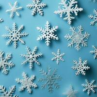 white snowflakes on light blue background photo