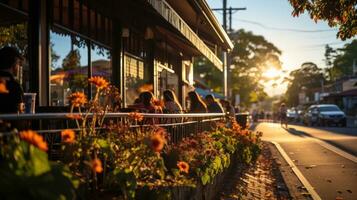 Outdoor cafe on the street in the evening with sunbeams and visitors on terrace. photo