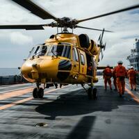 Helicopter landing on the deck of a ship photo