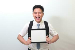 Indonesian senior high school student wearing white shirt uniform with gray tie showing empty frame. Blank space for typography or text to fill. Isolated image on white background photo