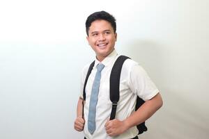 Indonesian senior high school student wearing white shirt uniform with gray tie smiling and looking at camera. Isolated image on white background photo