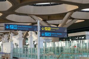 Directional sign at the airport as information for passengers. Yogyakarta International Airport YIA is modern facility serving international and domestic flights. Kulon Progo - Indonesia 09 03 2023 photo