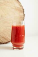 tomato juice in clear glass on white background, copy space photo