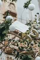 Christmas outdoor decoration on the building. Pine branches and classical Christmas balls in trendy white and silver colors. Street Christmas decoration concept photo