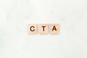 Top view of CTA letter or Call To Action on wooden cube letter block on white background. Business concept photo