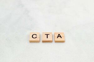 Top view of CTA letter or Call To Action on wooden cube letter block on white background. Business concept photo