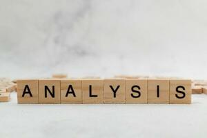 Top view of Analysis word on wooden cube letter block on white background. Business concept photo