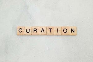 Top view of Curation word on wooden cube letter block on white background. Business concept photo