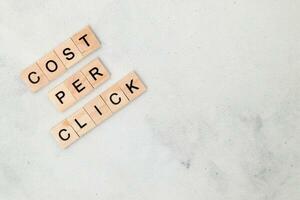 Top view of Cost Per Click word on wooden cube letter block on white background. Business concept photo