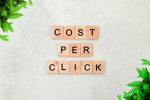 Top view of Cost Per Click word on wooden cube letter block on white background. Business concept photo