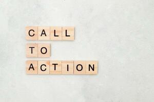 Top view of Call To Action word on wooden cube letter block on white background. Business concept photo