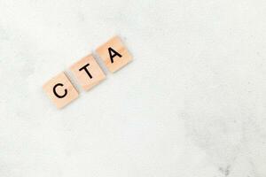 Top view of CTA letter or Call To Action on wooden cube letter block on white background. Business concept photo