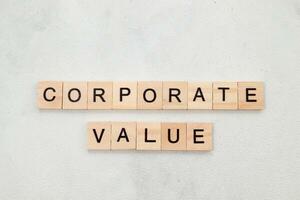 Top view of Corporate Value word on wooden cube letter block on white background. Business concept photo