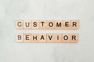 Top view of Customer Behavior word on wooden cube letter block on white background. Business concept photo