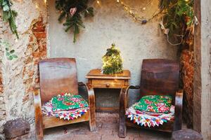 Christmas family garden or front porch. Rustic boho outdoor decor and old wooden table and armchairs photo