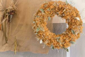 Big yellow wreath of stabilized moss. Halloween and Thanksgiving fall decoration photo