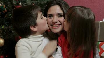 Attractive brunette woman with young kids smiling for the camera video