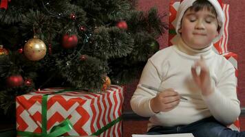 Little boy thinks up the letter to the Santa Claus video