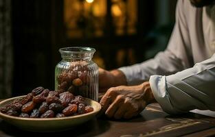 A Middle Eastern man is praying during Ramadan. He eats dates and drinks water. AI Generative photo