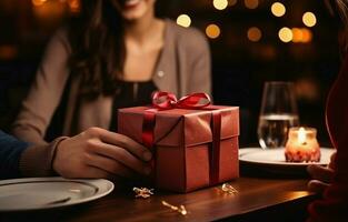 On Valentine's Day, a young couple sits at a restaurant table and the man gives a gift box to the young woman. The close-up shot has a selective focus. AI Generative photo