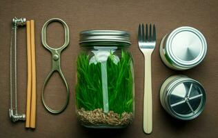 Glass jar, bottle, metal cup, straws for drinking, bamboo cutlery and lunch boxes on green grass, moss background. Top view. Sustainable lifestyle. Zero waste. AI Generative photo