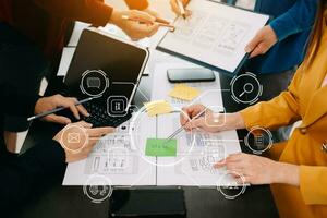 Close up view of UI developer team brainstorming on their project with laptop, smartphone and digital tablet. Creative digital development agency. with virtual icon photo