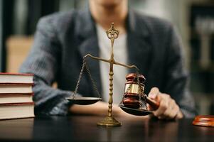 Male lawyer in the office with brass scale on wooden table. justice and law concept in morning light photo