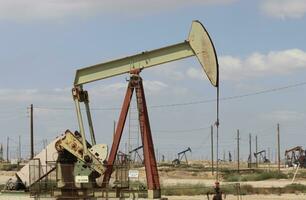 Industrial Oil Pump in the California Desert. Fading Oil industry as California Transfers to Clean Energy. photo