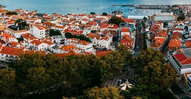 Aerial drone view of historic centre of Cascais, Portugal with the merry-go-round is visible in foreground photo