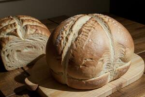 Tempting Delights Freshly Baked Bread on a Rustic Table. AI Generated. photo