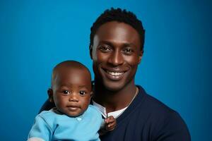 Studio portrait of handsome man holding infant baby in his hands on different colour background photo