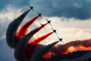 Aerobatic team at airshow. Flight demonstration and formation flying. Air force and military show. Airport and air base. Aviation and aircraft. Fly and flying. photo