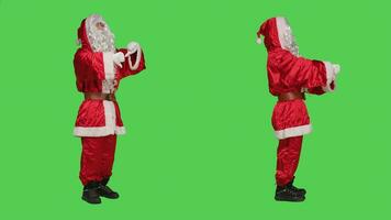 Father christmas gives thumbs down in studio, expressing frustration and disapproval when he should be spreading joyful holiday spirit. Santa claus showing dislike sign, displeased man. photo