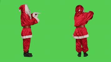 Santa claus feels overworked, doing timeout sign to express burnout and ask for a break in studio. Seasonal character in festive costume being tired, refusing to work with no pause. photo
