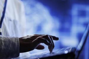 Licensed technician writes code on laptop to visualize artificial intelligence neural networks using augmented reality technology, close up. Server hub expert runs AI script for information processing photo