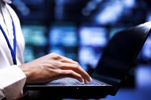 Expert servicing server rows with high computing power enabling hyperscale data center to support demanding applications, including artificial intelligence and neural network workloads photo