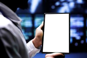 Supervisor using mock up tablet to inspect supercomputers doing complex computations. Professional preventing strain on data center equipment caused by AI applications ramping up power usage photo