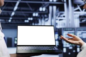 Close up shot of mock up laptop used by precise worker in data center supercomputer room delivering massive computing power, capable of processing and storing vast amounts of datasets photo