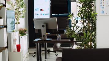 Boardroom office space with desks and stationary tools used for everyday executive tasks in company department place. Empty startup coworking space, small business decorations. photo